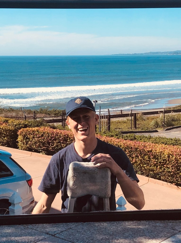 WCSC crew member cleaning windows with ocean view in Santa Cruz
